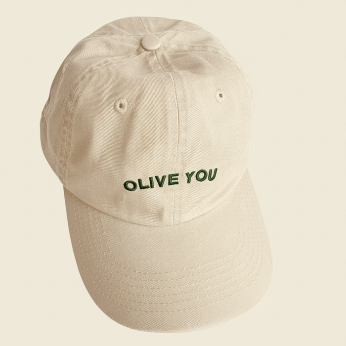 Beige cap with 'OLIVE YOU' text on a beige background